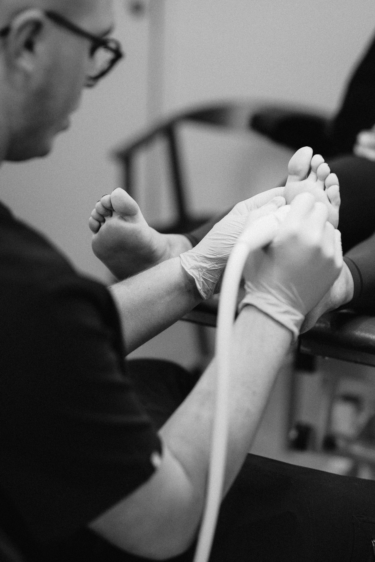 Specialist podiatrist examining a patient's foot at The Verruca Clinic NI